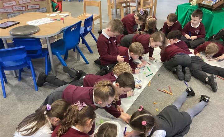 Reception class taking part in National Storytelling week by drawing aliens