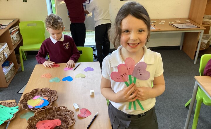 Pupil holding up their "word bouqet" using tricky words