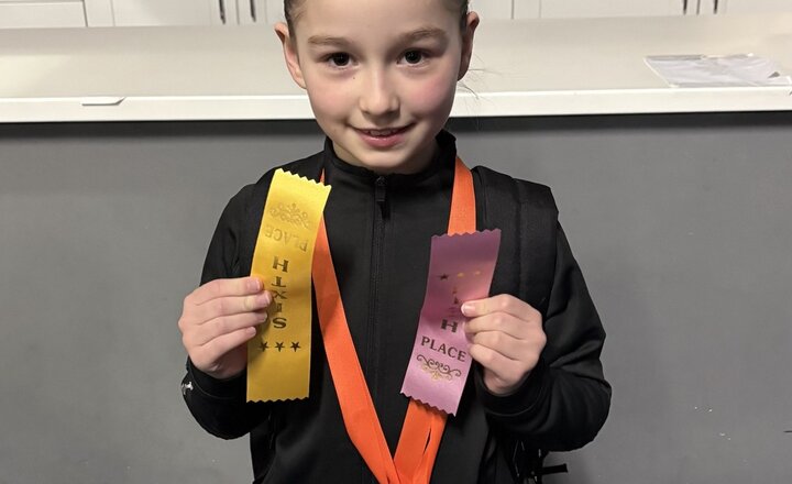 St Bede's Year 4 pupil showing their achievement certificate