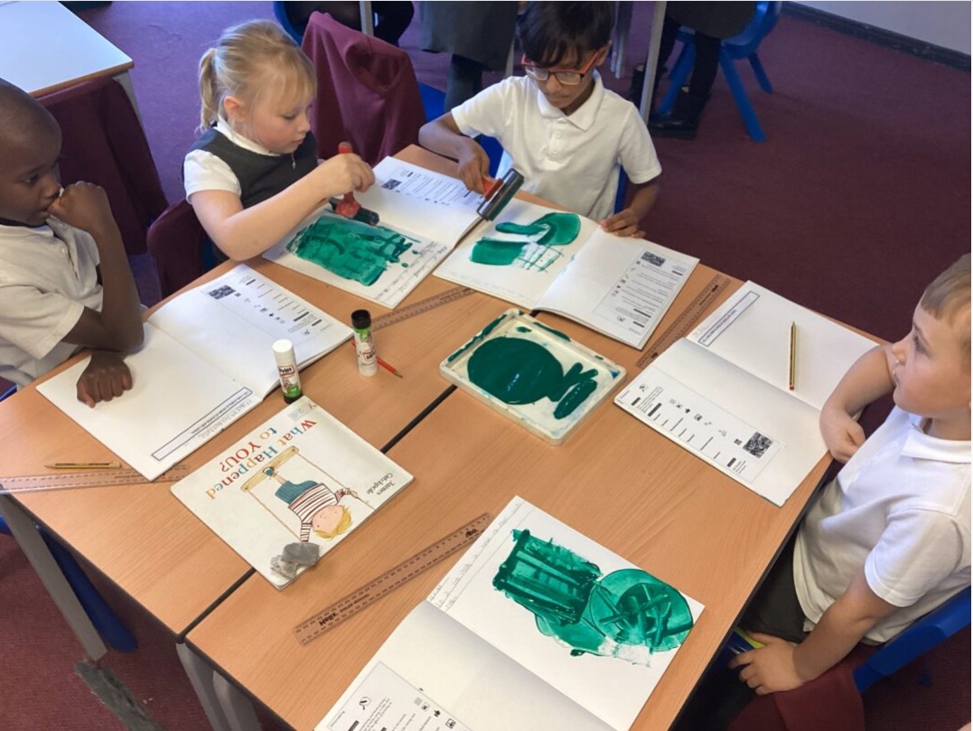 St. Bede’s Year 3 children practising printmaking techniques with rollers, experimenting with stamping, cross‑hatching, twisting, and varied rolling movements