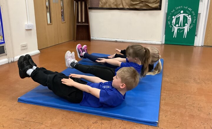 Sacred Heart pupils stretching and practising their gymnastics skills 