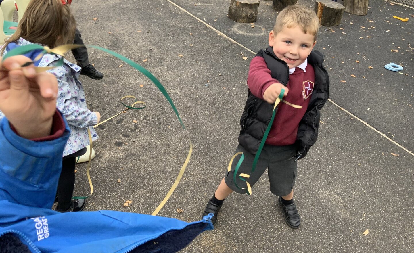 Image of Playing with and making resources outside in Nursery