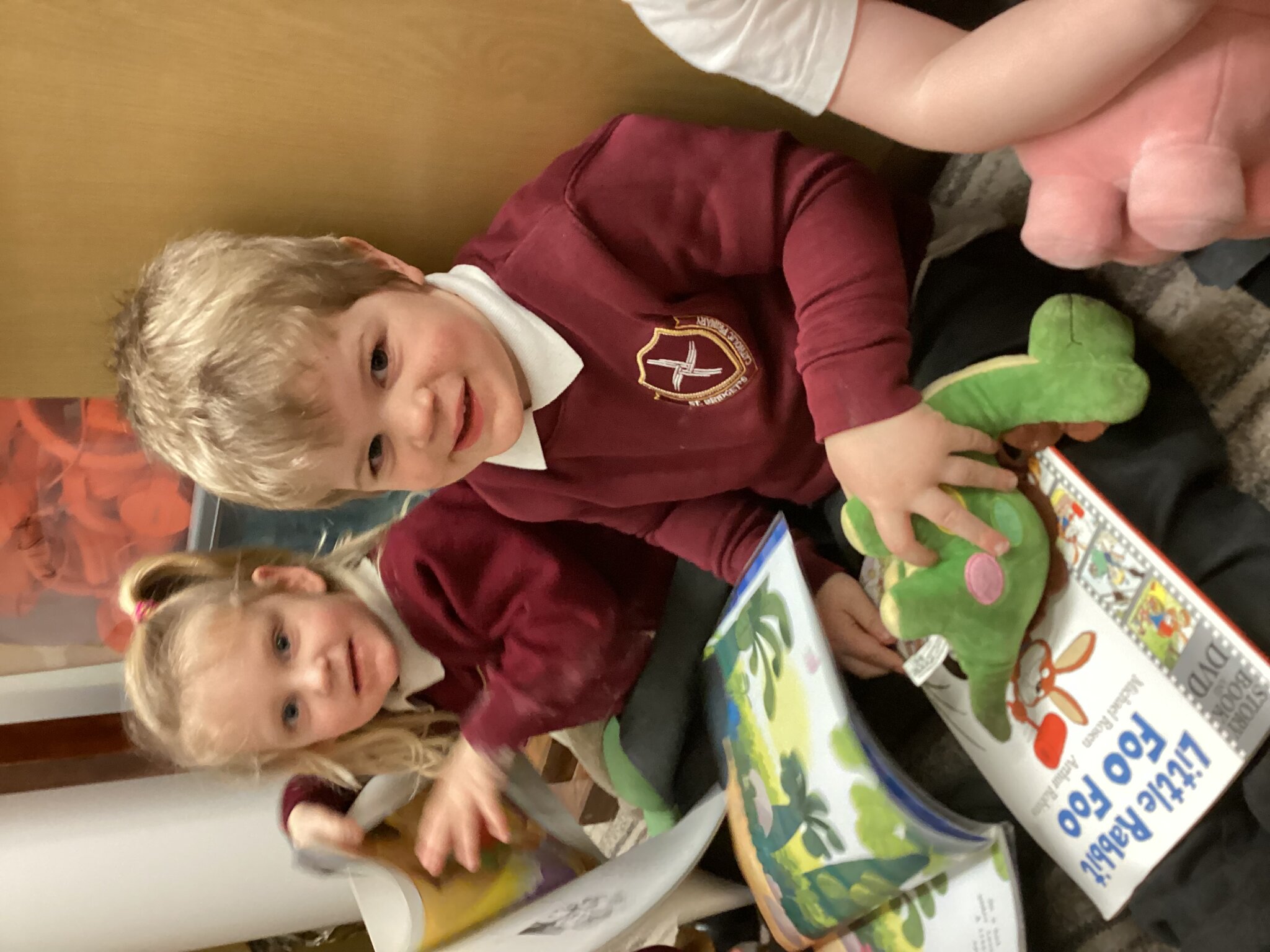 Image of Sharing a story with a teddy in Nursery