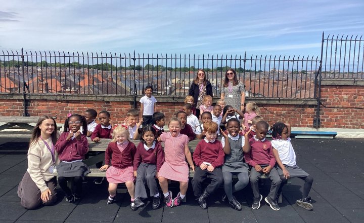 Pupils and Teachers from St Cuthbert's Hartlepool sat on their roof garden