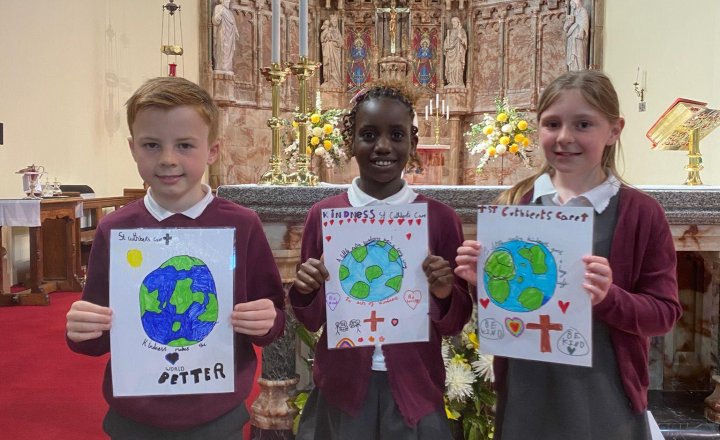 Three St Cuthbert's pupils, attending the special Mass in honour of St Cuthbert's Care