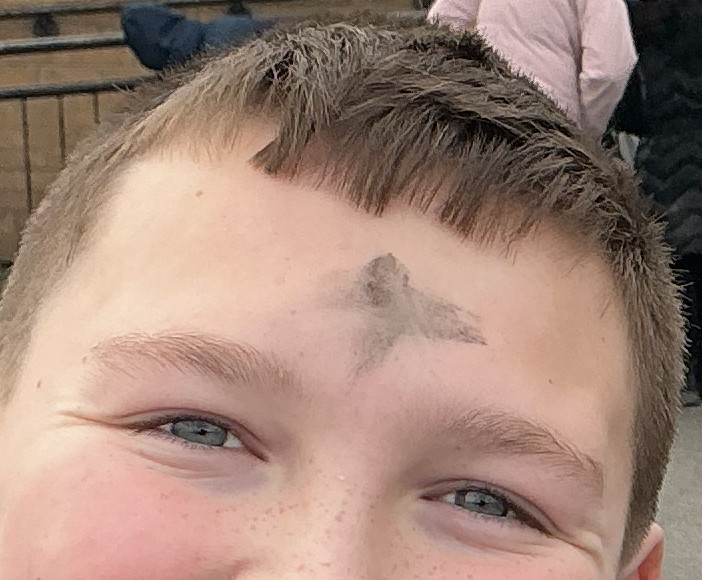 Pupil with the cross marked on their head to celebrate Ash Wednesday