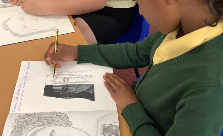 A St Joseph's pupil creating their beautiful greyscale portrait during an Art lesson.