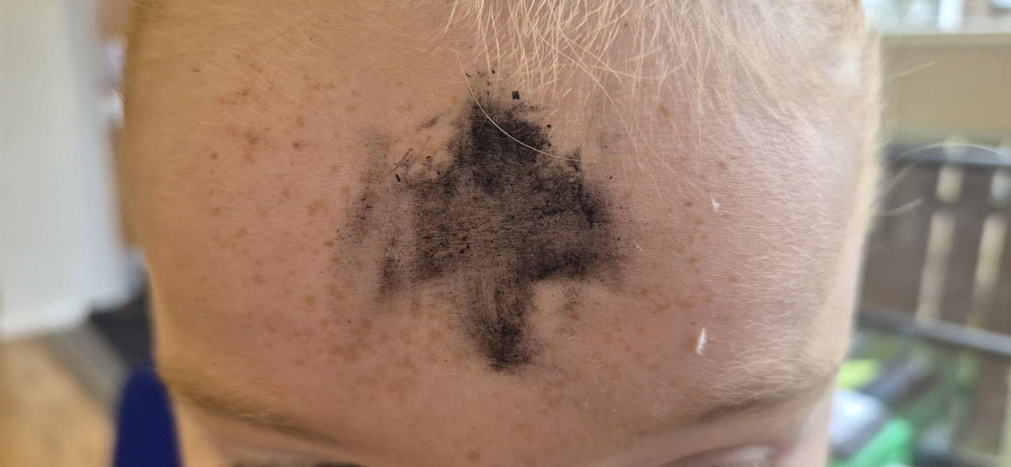 Mark of the cross in ash to celebrate the beginning of the Lent season