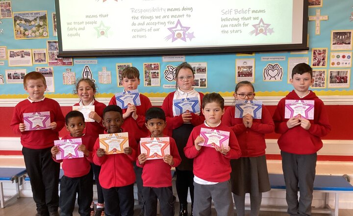 St Teresa's pupils showing their Virtue certificates