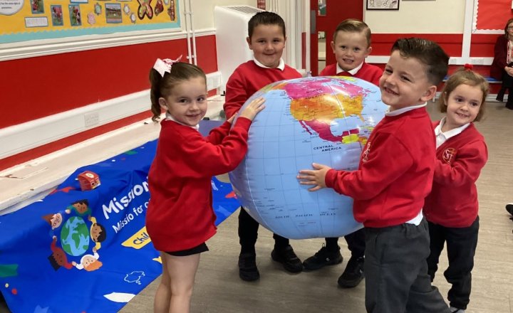 St Teresa's pupils holding a inflatable globe during their session with Maria from Mission Together