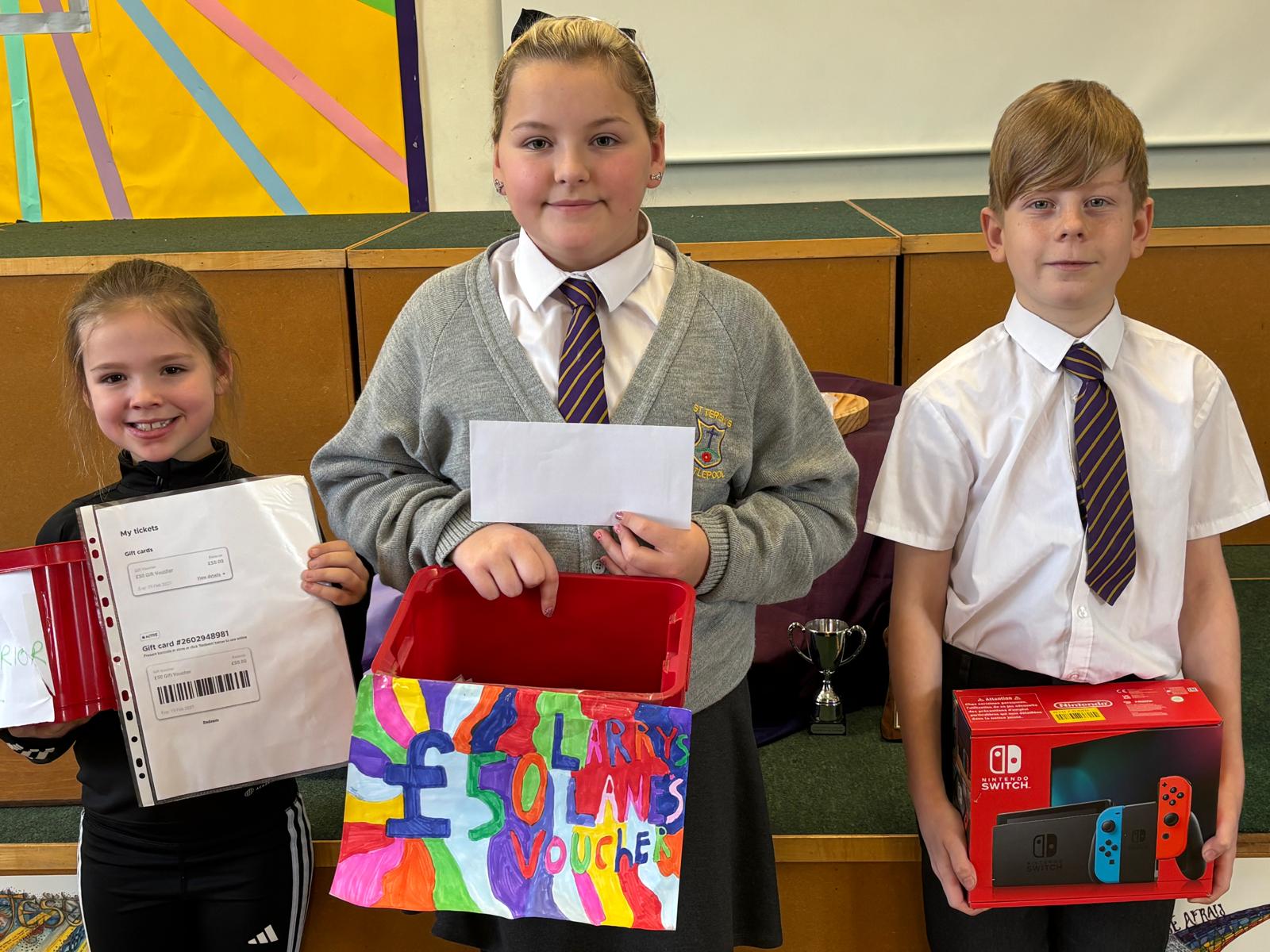 Pupils showing their winnings from the Virtue raffle draw!
