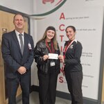 Image of A former student collects a cheque towards her charity "All Ears"