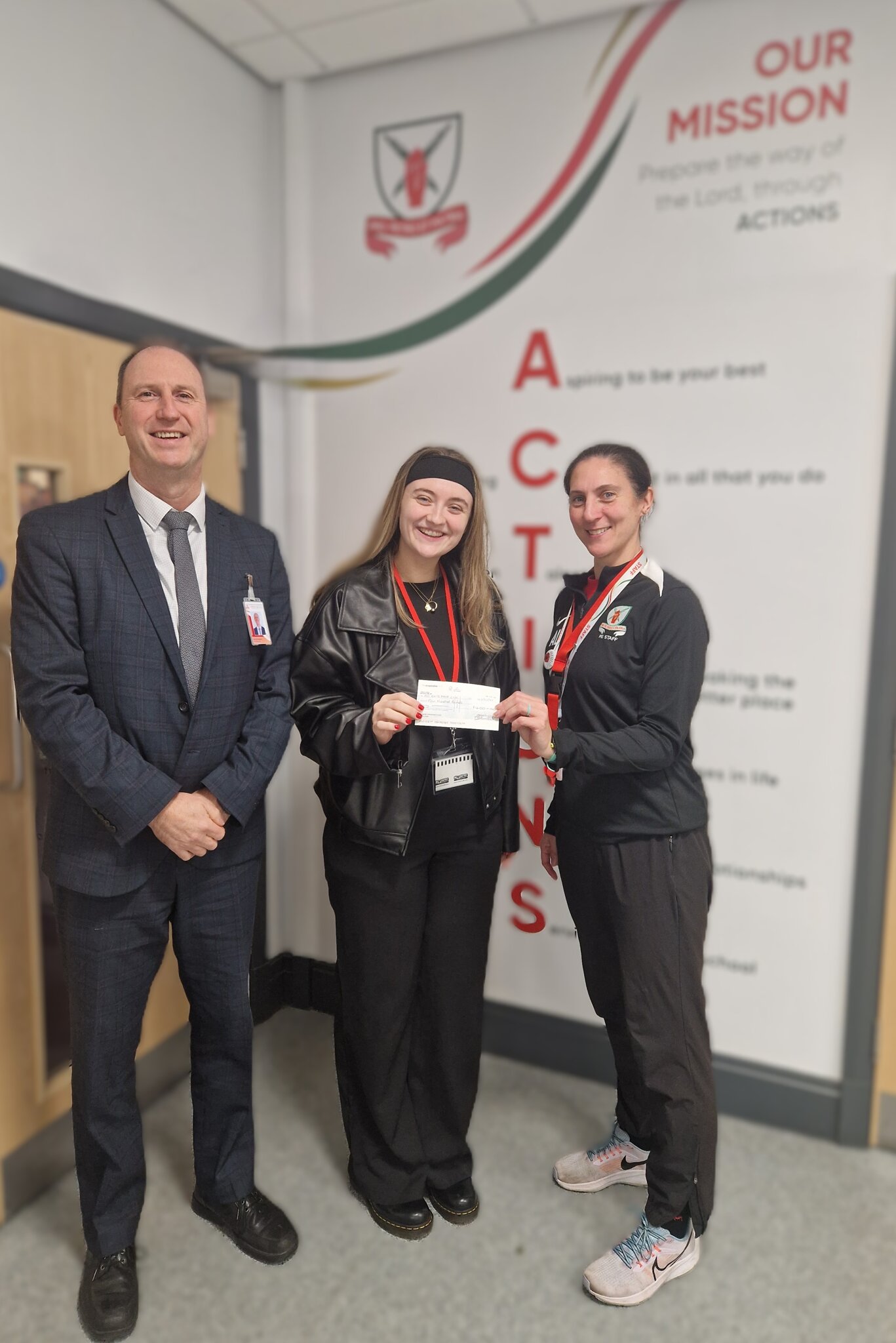 Image of A former student collects a cheque towards her charity "All Ears"