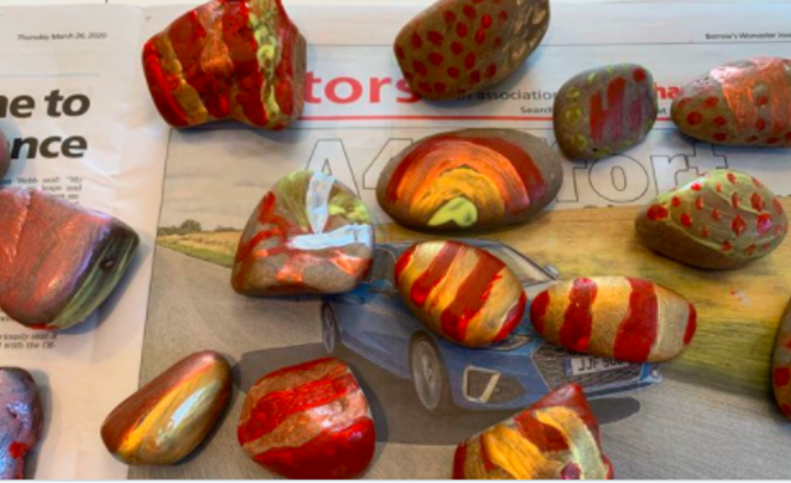 Image of Spreading a smile by painting stones