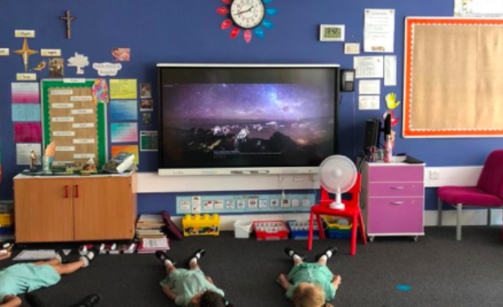 Image of KS1 Key worker children cooling down and listening to relaxing music this afternoon.