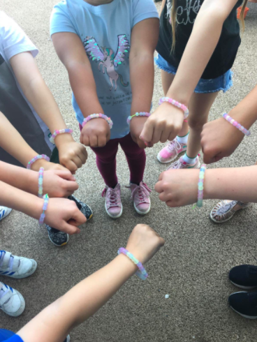 Image of Staff loved making glow in the dark bracelets today with the key worker children!