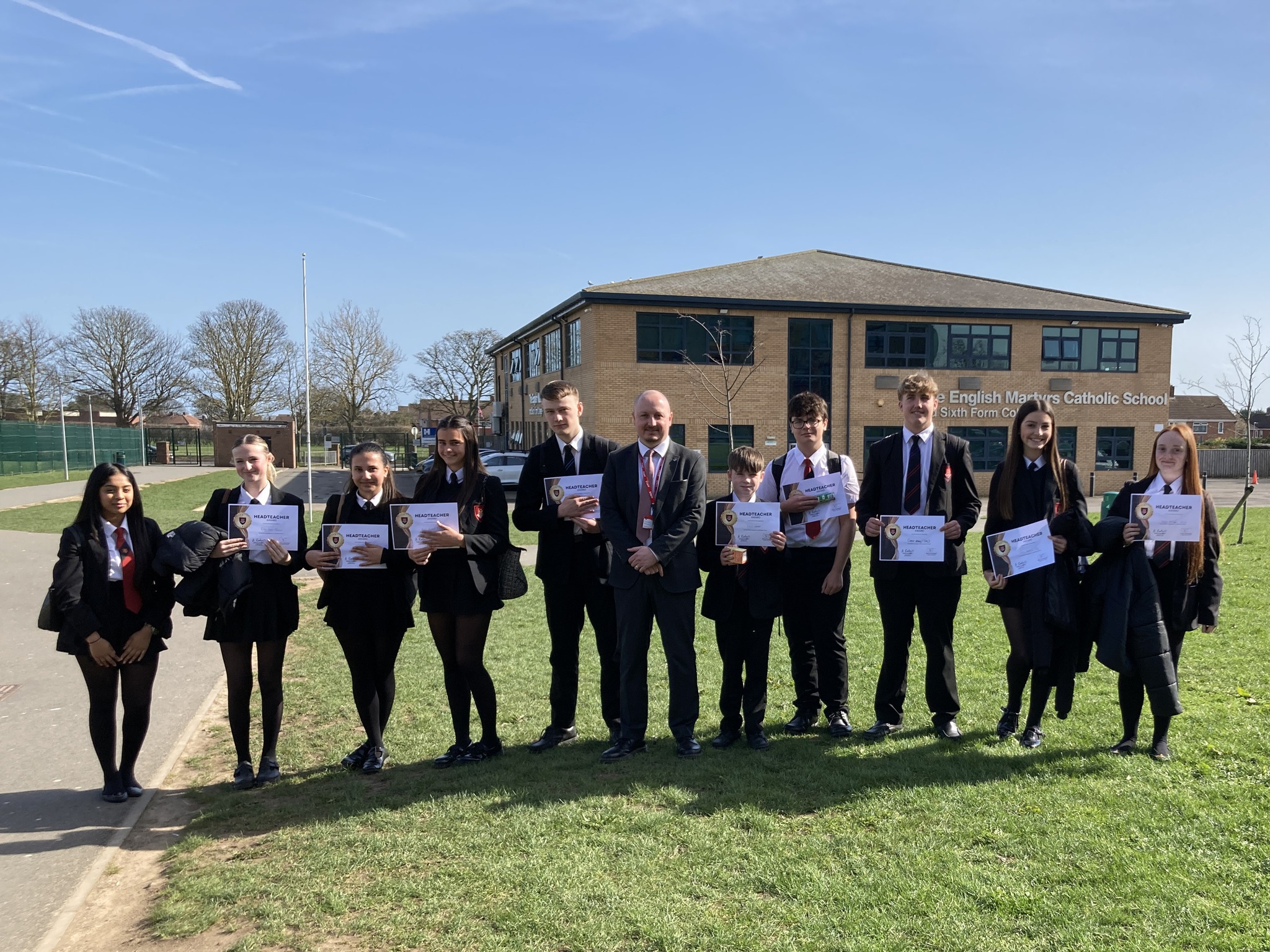 EMS Headteacher Award winners presenting their certificates