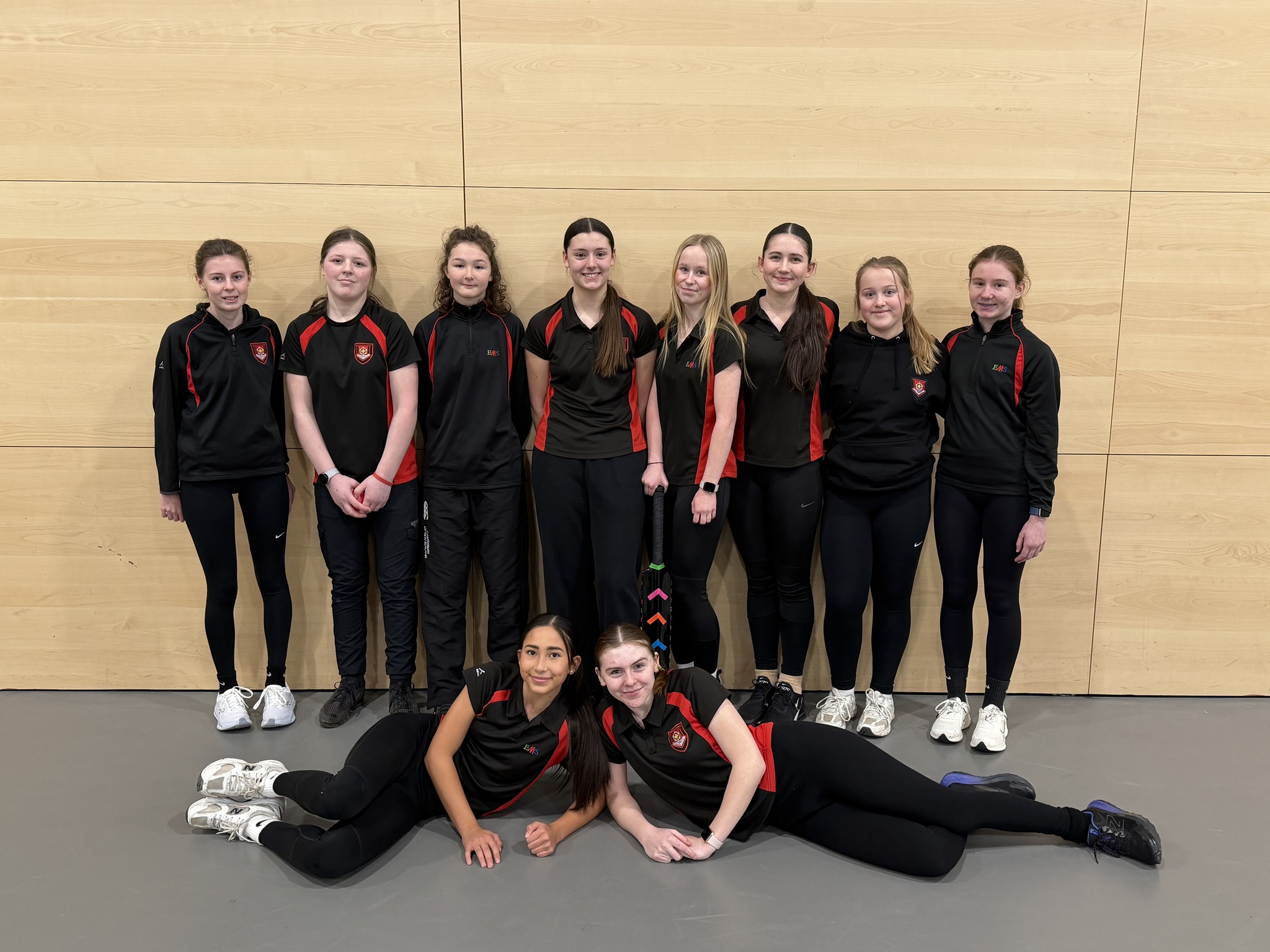 The EMS cricket team celebrating finishing top of their group