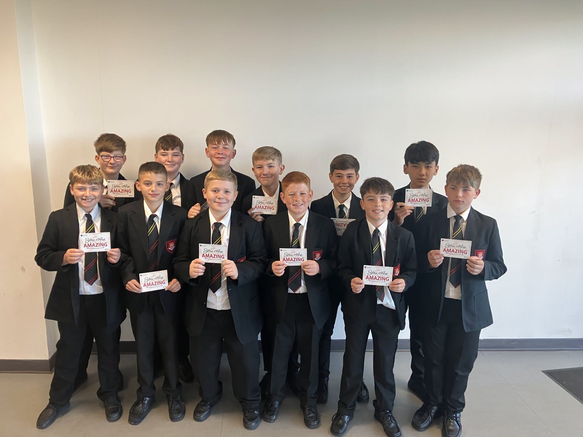 EMS Year 8 Boys Rugby Team with their celebratory cards after three wins from their first competitive matches of the year